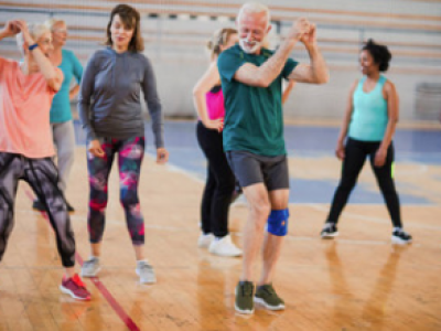 elderly-people-exercising-with-rubber-band-together-with-instructor-health-club 1